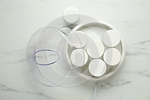 Modern yogurt maker with jars on white marble table, flat lay