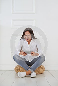 Modern young businesswoman using her tablet with joyful facial e