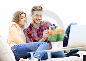 Modern young couple checks the photos on the camera