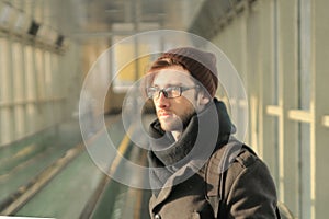 Modern young man standing in the subway