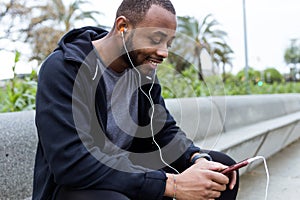 Modern young man using his mobile phone in the street.