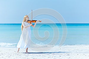 modern young woman in light dress enjoying playing on seacoast