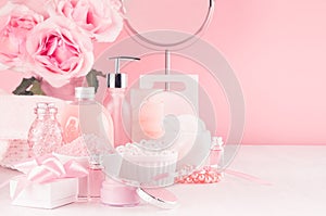 Modern youth bathroom or dressing table design in pastel pink color -  flowers, cosmetic products, bath accessories, jewelry.