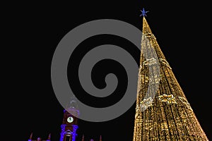 Modernisme plaza in Valencia, Spain, at nightfall illuminated by led shinny christmas tree and city hall building in the