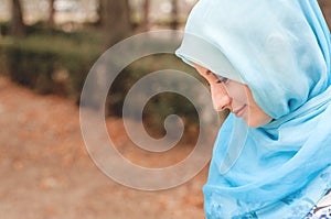 Modest girl in a blue kerchief. Muslim girl.