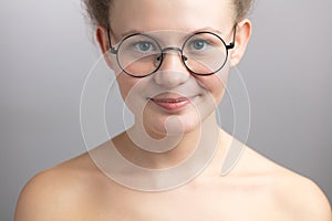 Modest nude girl in round glasses