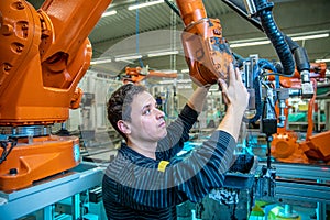 Modification of the robot to produce a new product. technically, the worker adjusts the machine. concept industry 4.0