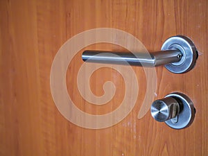 Modren style door handle on natural wooden door