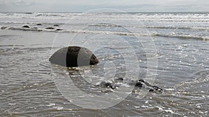 Moeraki boulders, ocean surf and empty New Zealand beach