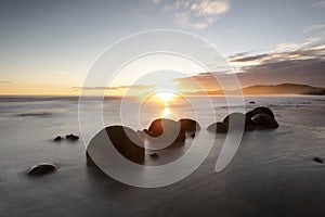 Moeraki Boulders at sunrise with a colourful sky, New Zealand