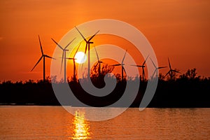 Moerdijk Netherlands, sunset winth windmills by the lake Vokerak river in Holland windmill energy sunset