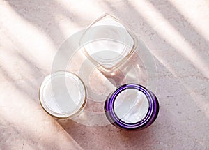 Moisturising beauty cream jars, skincare and spa cosmetics on stone background in summer at sunset, cosmetic product and skin care