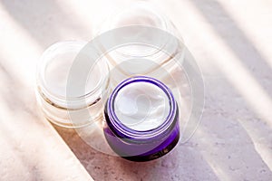 Moisturising beauty cream jars, skincare and spa cosmetics on stone background in summer at sunset, cosmetic product and skin care