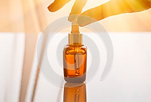 Moisturizing anti-aging face serum in a dark glass bottle. Hyaluronic Acid photo