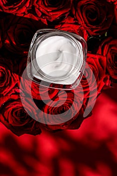 Moisturizing beauty face cream for sensitive skin and red roses flowers, luxury clean skincare cosmetics on floral background