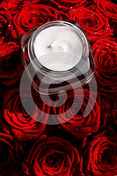 Moisturizing beauty face cream for sensitive skin and red roses flowers, luxury clean skincare cosmetics on floral background