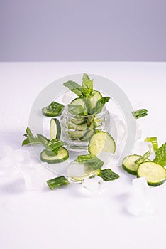 moisturizing cosmetics based on natural extracts of aloe, cucumber and ice in a glass container on a white background