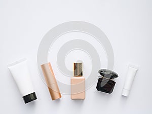 moisturizing creams for face and eyes, perfume, foundation and lipstick - cosmetics on white background, copy space