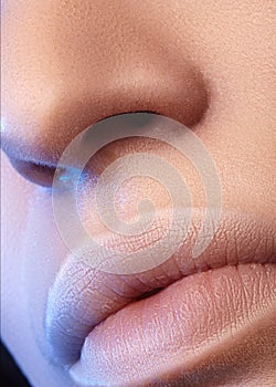 Moisturizing lip balm, lipstick. Close-up of beautiful lips. Full lips with natural lip makeup. Filler Injections