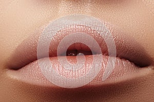 Moisturizing lip balm, lipstick. Close-up of beautiful lips. Full lips with natural lip makeup. Filler Injections