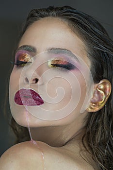 Moisturizing lip balm, lipstick. Closeup of beautiful wet lips. Nice full lips with gloss lip makeup. Filler injections