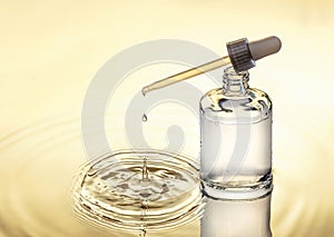 Moisturizing serum for dry skin, yellow background, pipette with drop, splash.