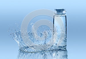Moisturizing shampoo on the blue water background with big splash around the bottle