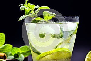 Mojito cocktail on dark wood table. The mojito, a caipirinha-like rum drink with mint leaves