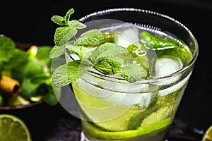 Mojito cocktail on dark wood table. The mojito, a caipirinha-like rum drink with mint leaves