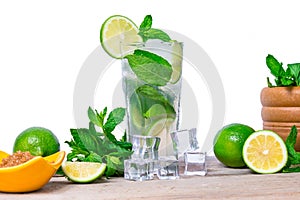 Mojito cocktail with fresh lime, mint leaves and ice cubes in a transparent glass