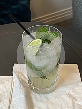 Mojito Cocktail with lime and mint garnish in a crystal glass