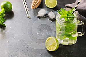 Mojito cocktail in mason jar on black. Close up. Copy space.