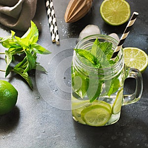 Mojito cocktail in mason jar on black. Close up. Copy space.