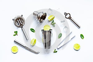 Mojito cocktail set with bar tools and utensils with lime and mint, flat lay