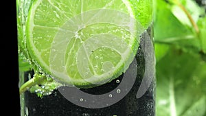 Mojito cocktail or soda drink with lime and mint. Close up