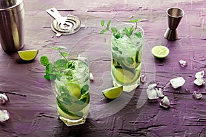 Mojito cocktail. Summer cold drink with lime, fresh mint, and ice. Cool beverage