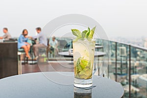 Mojito cocktail on table in rooftop bar