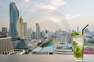 Mojito cocktail on table in rooftop bar with Bangkok city view point in Bangkok Thailand. Beautiful rooftop bar in Bangkok