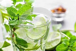 Mojito Cubano or caipirinha cocktail, iced drink with lime and mint photo