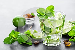 Mojito Cubano or caipirinha cocktail, iced drink with lime and mint photo