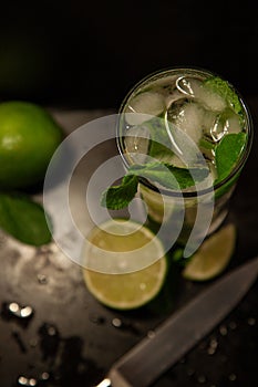 Mojito, fresh mint and lime on a black background