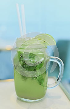 Mojito with a lime and mint in a glass mug