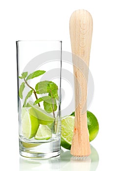 Mojito mix: lime, mint in glass and muddler