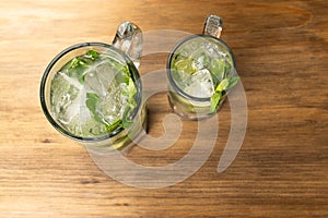 Mojito on rustic wooden background. Frutal alcoholic cocktails. Cuban drinks concept with space for text