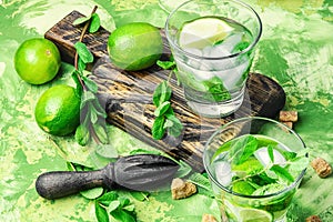 Mojitos cocktail with lime and mint leaves