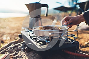 Moka pot coffee campsite morning lifestyle, person cooking hot drink in nature camping outdoor, cooker prepare breakfast picnic