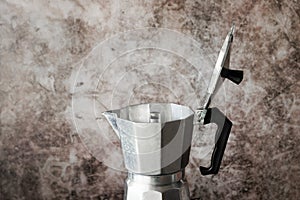 Moka pot coffee maker on grunge texture wall