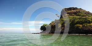 Mokolii island [also known as Chinamans Hat] as seen from the water on the North Shore of Oahu Hawaii USA