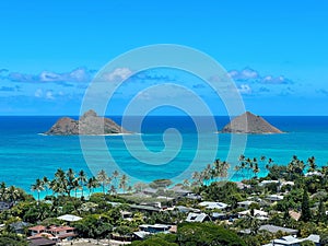 Mokulua Islands and Lanikai Beach in Hawaii against a blue sky