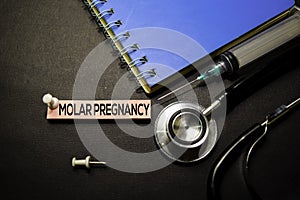 Molar Pregnancy text on Sticky Notes. Top view isolated on black background. Healthcare/Medical concept